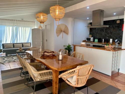 a kitchen and living room with a wooden table and chairs at PicoTerrace in Madalena