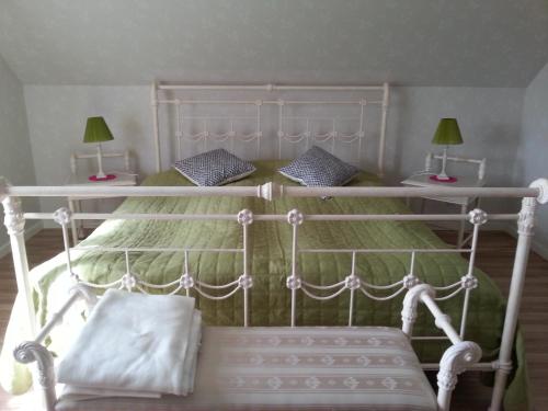 a bedroom with a white bed with two lamps at Joastorps Bed & Breakfast in Ullared