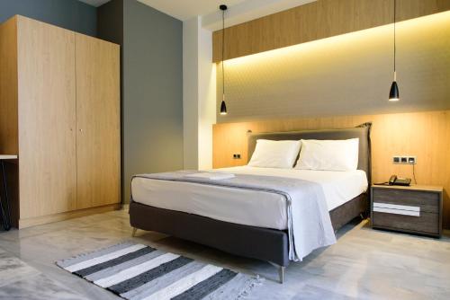 a hotel room with a bed and a desk at Eva Apartments in Piraeus