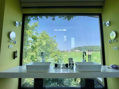 a bathroom with two sinks and a large window at Aqua Star Villa Homestay in Dongshan
