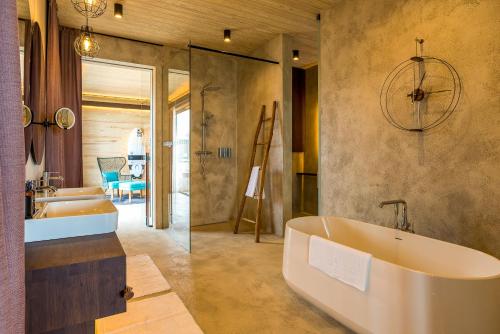 a bathroom with a large tub and a sink at Saba Rock Resort in Virgin Gorda