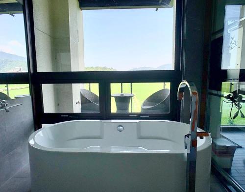 a large bath tub in a bathroom with a window at Aqua Star Villa Homestay in Dongshan