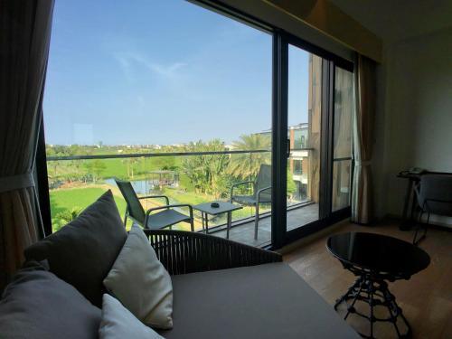 a living room with a couch and a large window at Aqua Star Villa Homestay in Dongshan