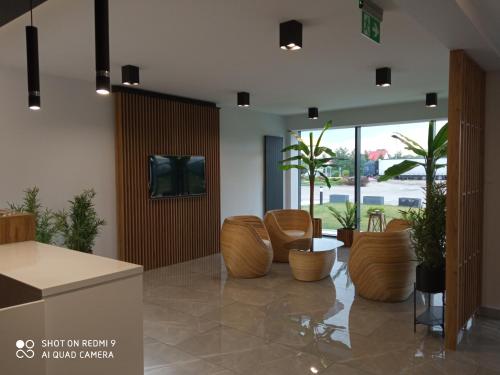 a lobby with chairs and a tv on a wall at HAVANA in Lublin