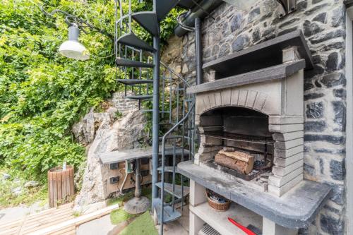 an outdoor brick oven with a staircase in a yard at Residence Le Terrazze in Perledo