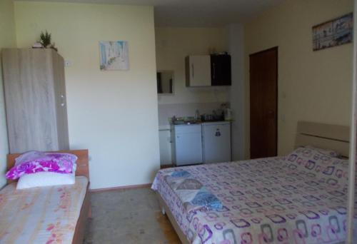 a small room with two beds and a kitchen at Marko Apartments in Struga