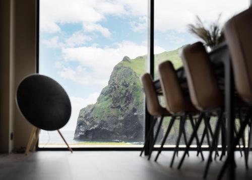 a room with a window with a view of a mountain at Luxury Ocean Villas in Vestmannaeyjar