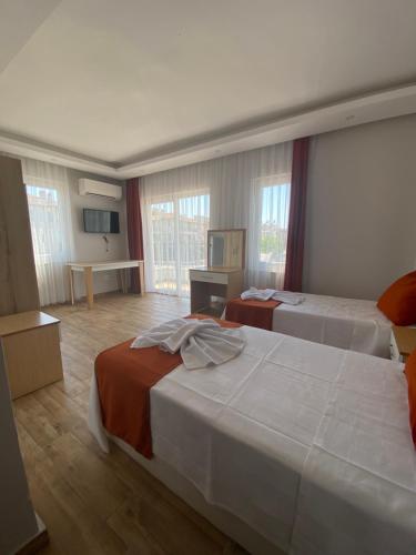 Ένα ή περισσότερα κρεβάτια σε δωμάτιο στο Kent Otel