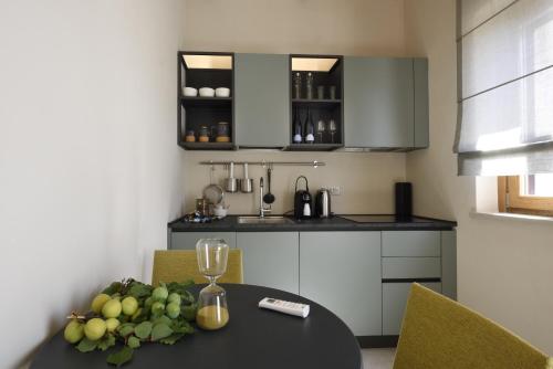 a kitchen with a table with a bowl of fruit on it at La Cascina di Chiara in San Martino sulla Marruccina