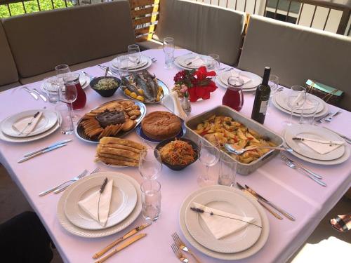 a table with plates and dishes of food on it at Villa Angel in Kamenari