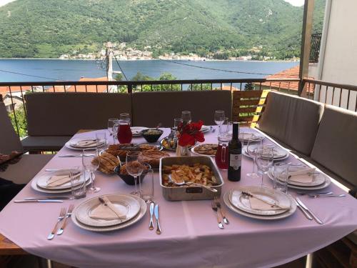 a table with a white table cloth with food on it at Villa Angel in Kamenari