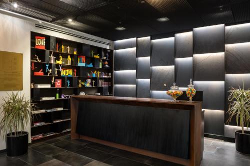 a lobby with a counter and shelves of shoes at Schumacher Hotel Haifa in Haifa