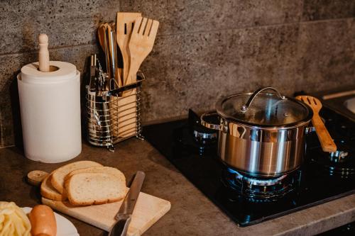 a stove top with a pot and a loaf of bread at Chalupa Lieskovec in Tatranska Strba