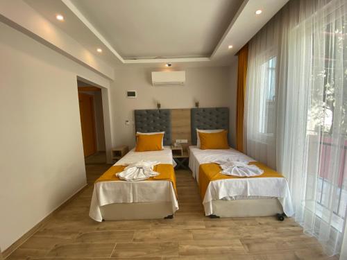 Ένα ή περισσότερα κρεβάτια σε δωμάτιο στο Kent Otel