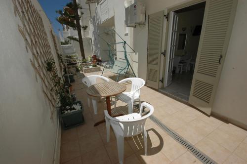 a balcony with a table and chairs on a balcony at Pension Ocean View in Naxos Chora