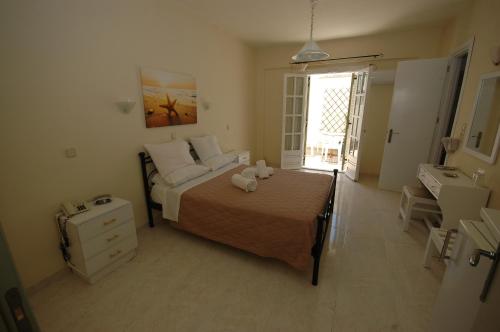 a bedroom with a bed and a bathroom with a window at Pension Ocean View in Naxos Chora