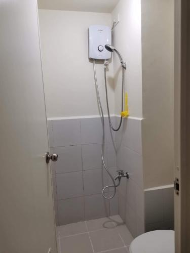 a bathroom with a shower with a toilet in it at Mack's Awesome Place 24 with Netflix and FastUnliwifi in Manila