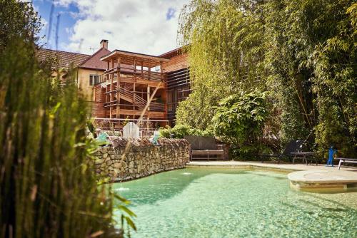 a swimming pool in front of a house at Relais Bernard Loiseau in Saulieu