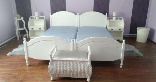 a white bed with a chair in a bedroom at Dancz Home in Dég