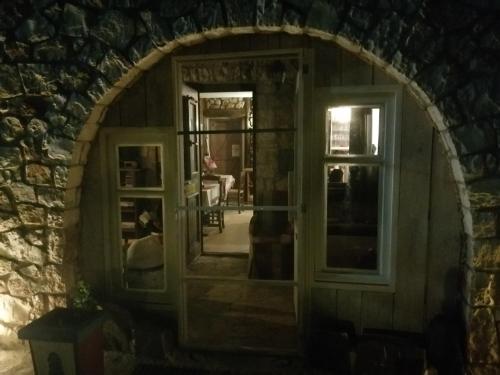 an arched doorway into a room with a window at Yono's Traditional House in Ano Ravenia