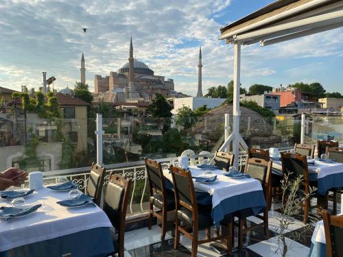 a restaurant with tables and chairs with a view of a city at Villa Sofia in Istanbul