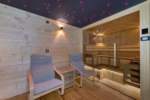 a sauna with two chairs and a table at Log House The River Pearl in Brod na Kupi
