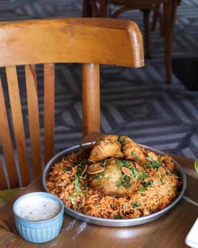 a pan of food sitting on a table at Crystal Suites in Amman