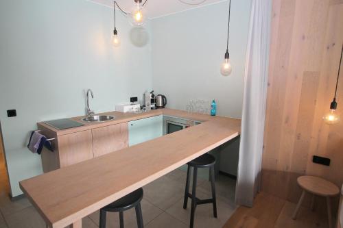 a kitchen with a wooden counter top in a room at Junior-Suite "Bellavista" mit Seeblick in Ascheberg