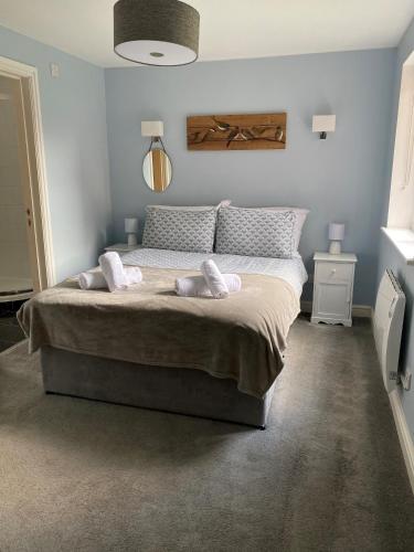 a bedroom with a large bed with two pillows on it at 15 Maple Court in Oxford