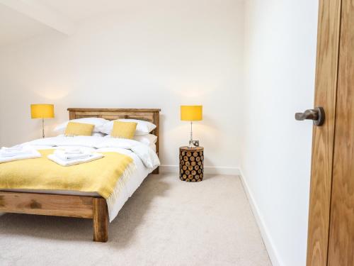 a bedroom with a bed with two lamps on it at Swallows Rest in Montgomery