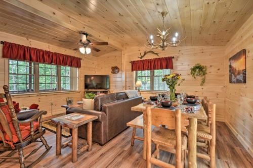 a living room with a couch and a table at Secluded Mountain Cabin in Wardensville! in Wardensville