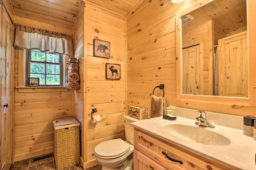 a wooden bathroom with a sink and a toilet at Secluded Mountain Cabin in Wardensville! in Wardensville