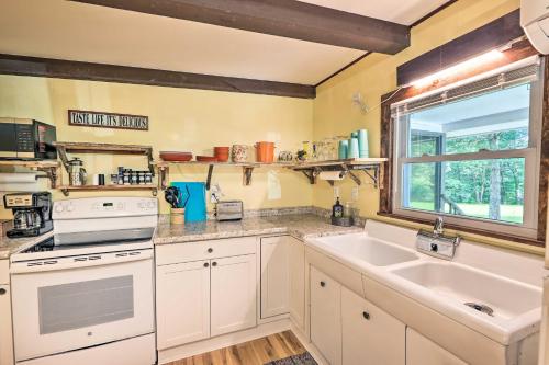 a kitchen with white cabinets and a sink and a window at Rustic Hideaway with Fire Pit Less Than 1 Mi to River! in Hillsboro