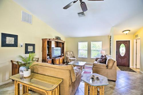 a living room with two couches and a table at Dock and Canal Access Cape Coral Family Home in Cape Coral
