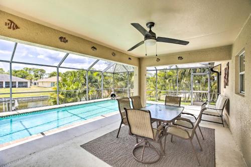 a dining room with a pool and a ceiling fan at Dock and Canal Access Cape Coral Family Home in Cape Coral