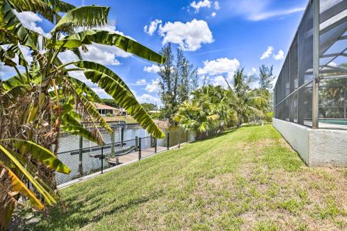 a grassy field next to a building at Dock and Canal Access Cape Coral Family Home in Cape Coral