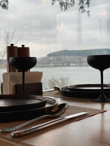 a table with black plates and utensils on a table at Едем in Brzezhany