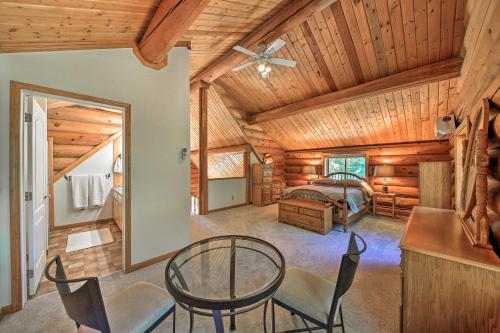 a bedroom with a bed and a table and chairs at Large Cabin with Fire Pit and Grill on 34 Acres! in Sagle