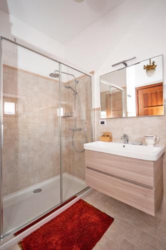 a bathroom with a shower and a sink and a mirror at B&B BONE NOVELLE dimora storica palazzo zuzi in LʼAquila