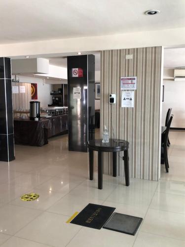 a room with a table and a refrigerator at Hotel Francis in Culiacán