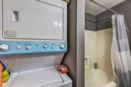 a small kitchen with a washer and dryer at Rustic Ruidoso Cabin with Large Deck and Grill! in Ruidoso