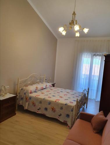 a bedroom with a bed and a couch at Relax da Giusy in Vatolla