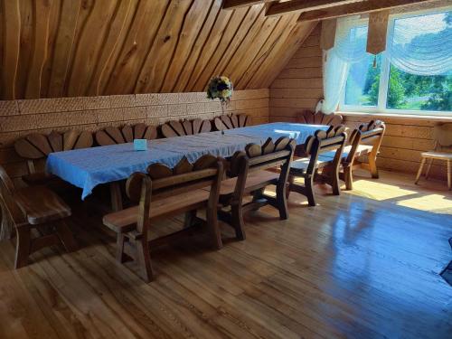a dining room with a blue table and chairs at Stay at Svaja in Plungė