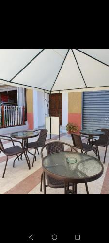a group of tables and chairs in a room at Relax da Giusy in Vatolla
