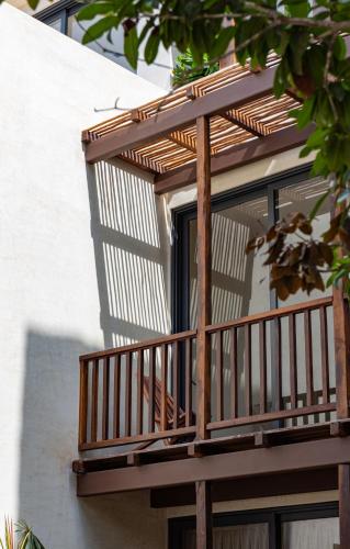 a wooden balcony on the side of a building at Unho Tulum in Tulum