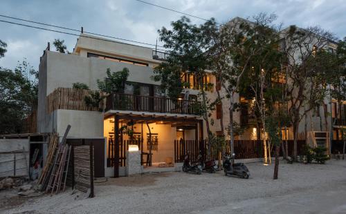 a building with two motorcycles parked in front of it at Unho Tulum in Tulum
