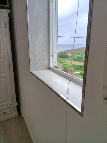 a window in a room with a view of a field at O Chaleco in San Ciprián