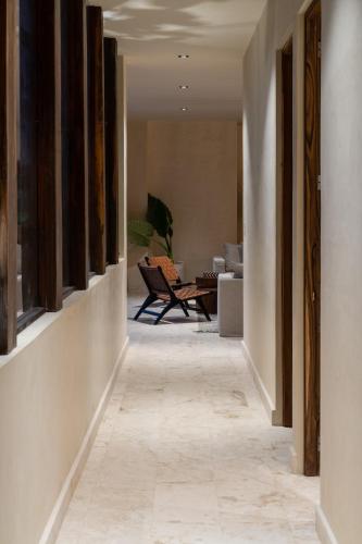 a hallway leading to a living room with a couch at Unho Tulum in Tulum