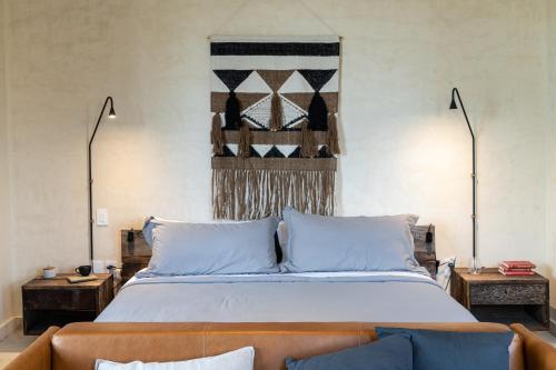 a bedroom with a large bed and a couch at Unho Tulum in Tulum