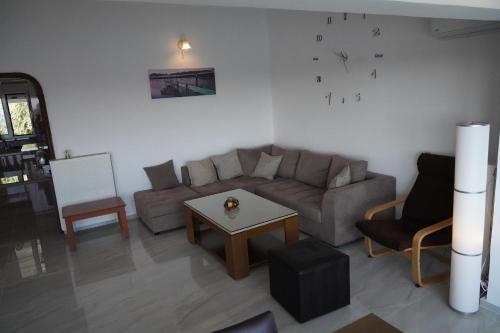 a living room with a couch and a table at Valtos View in Parga